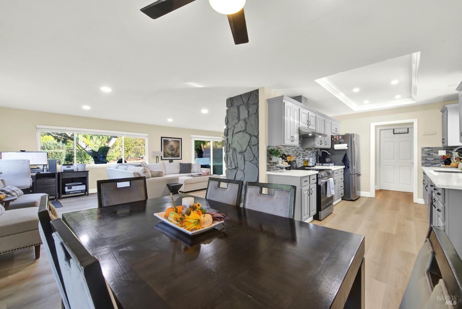 4118 Georgia Street Vallejo, CA 94591 - Photo 23 of 56 a kitchen with stainless steel appliances granite countertop a stove refrigerator and couches with wooden floor