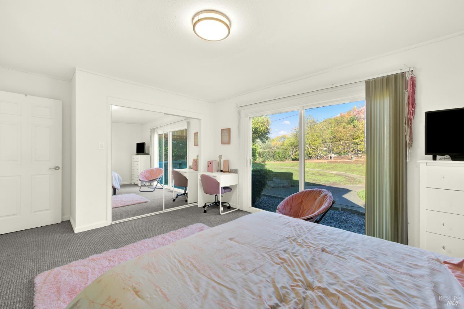 4118 Georgia Street Vallejo, CA 94591 - Photo 32 of 56 a bedroom with a bed and large windows