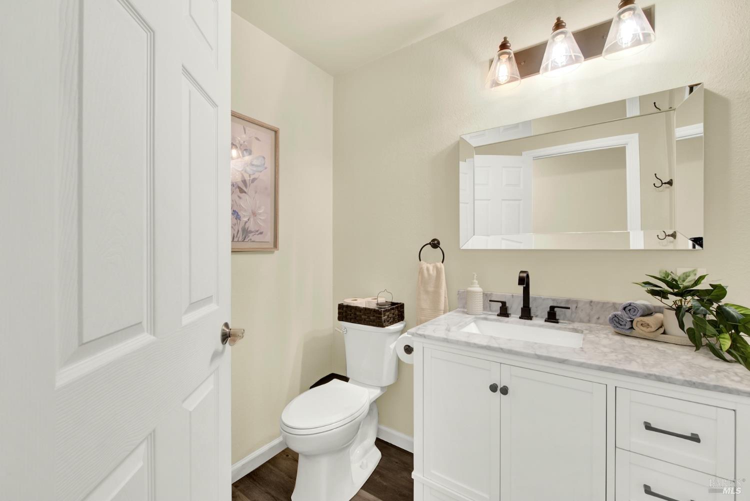 4118 Georgia Street Vallejo, CA 94591 - Photo 39 of 56 a bathroom with a granite countertop sink mirror vanity and toilet