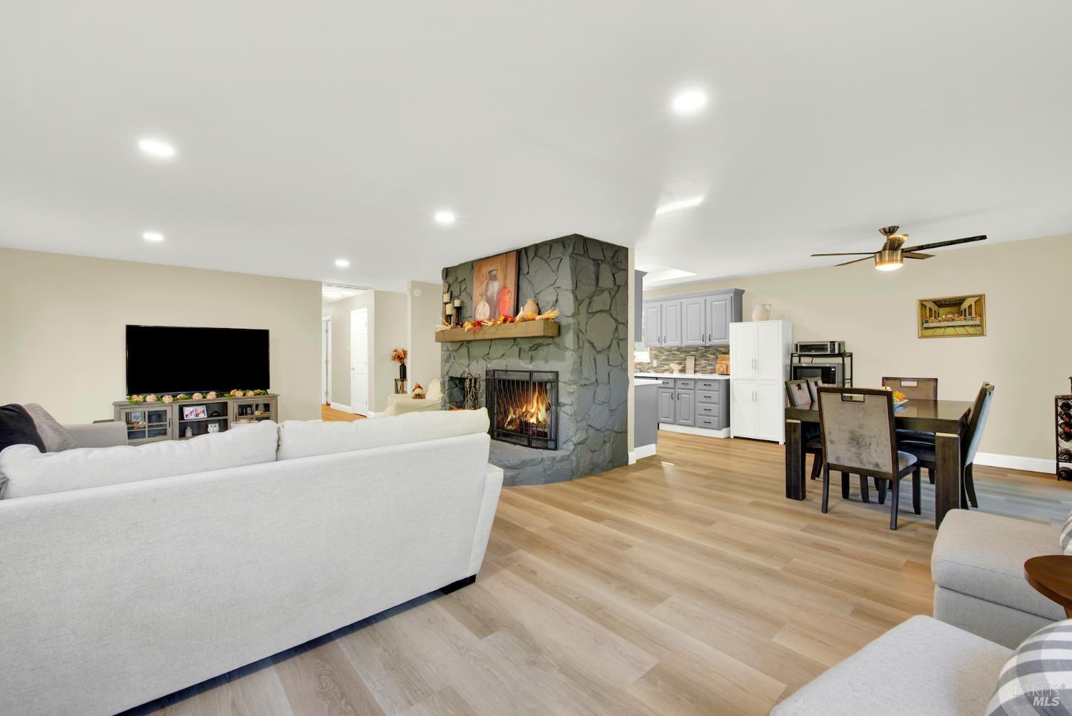 4118 Georgia Street Vallejo, CA 94591 - Photo 7 of 56 a living room with furniture a flat screen tv and a fireplace
