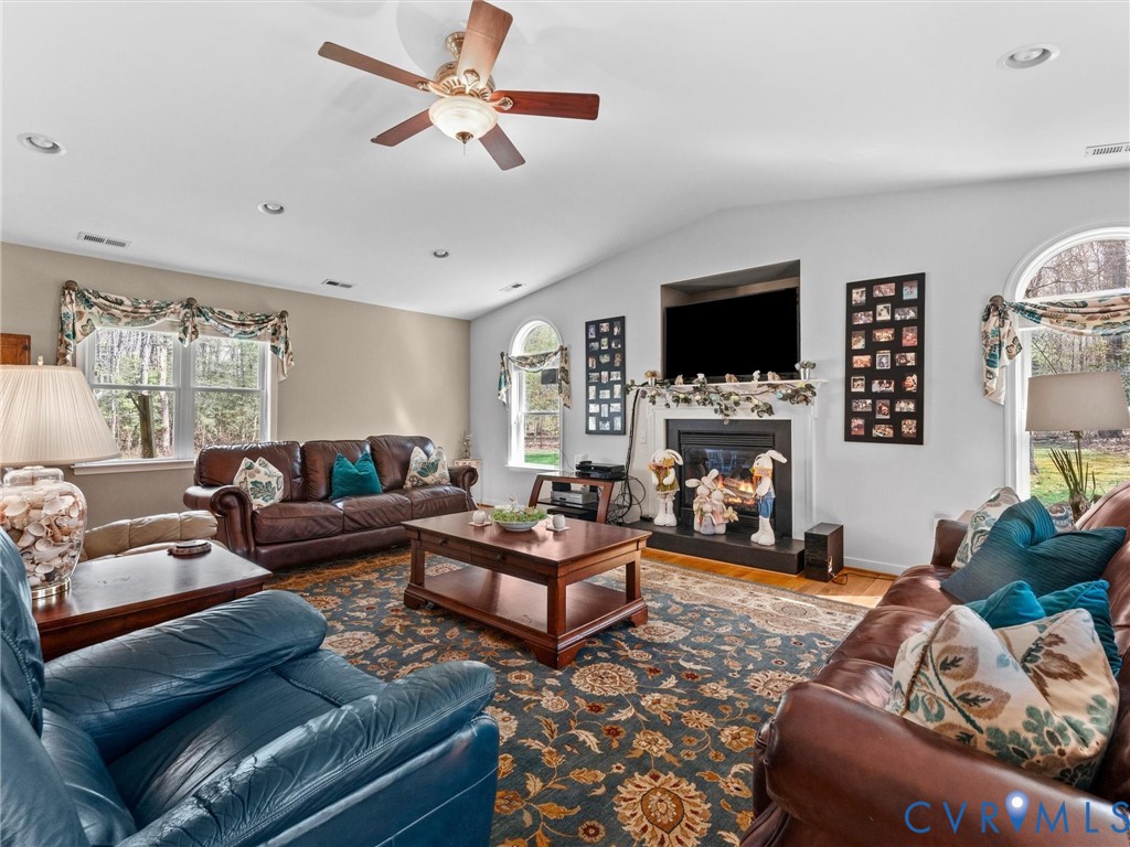 10488 Old Telegraph Road Ashland, VA 23005 - Photo 24 of 69 a living room with furniture a flat screen tv and a fireplace