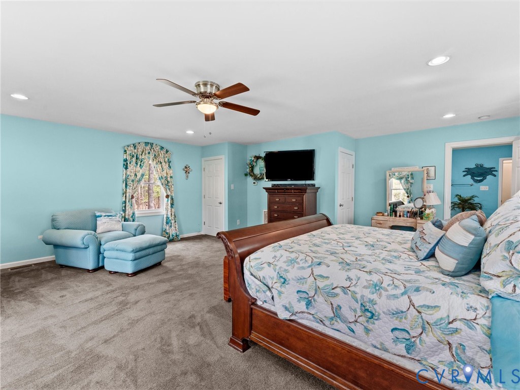 10488 Old Telegraph Road Ashland, VA 23005 - Photo 43 of 69 a bedroom with a bed and a chandelier