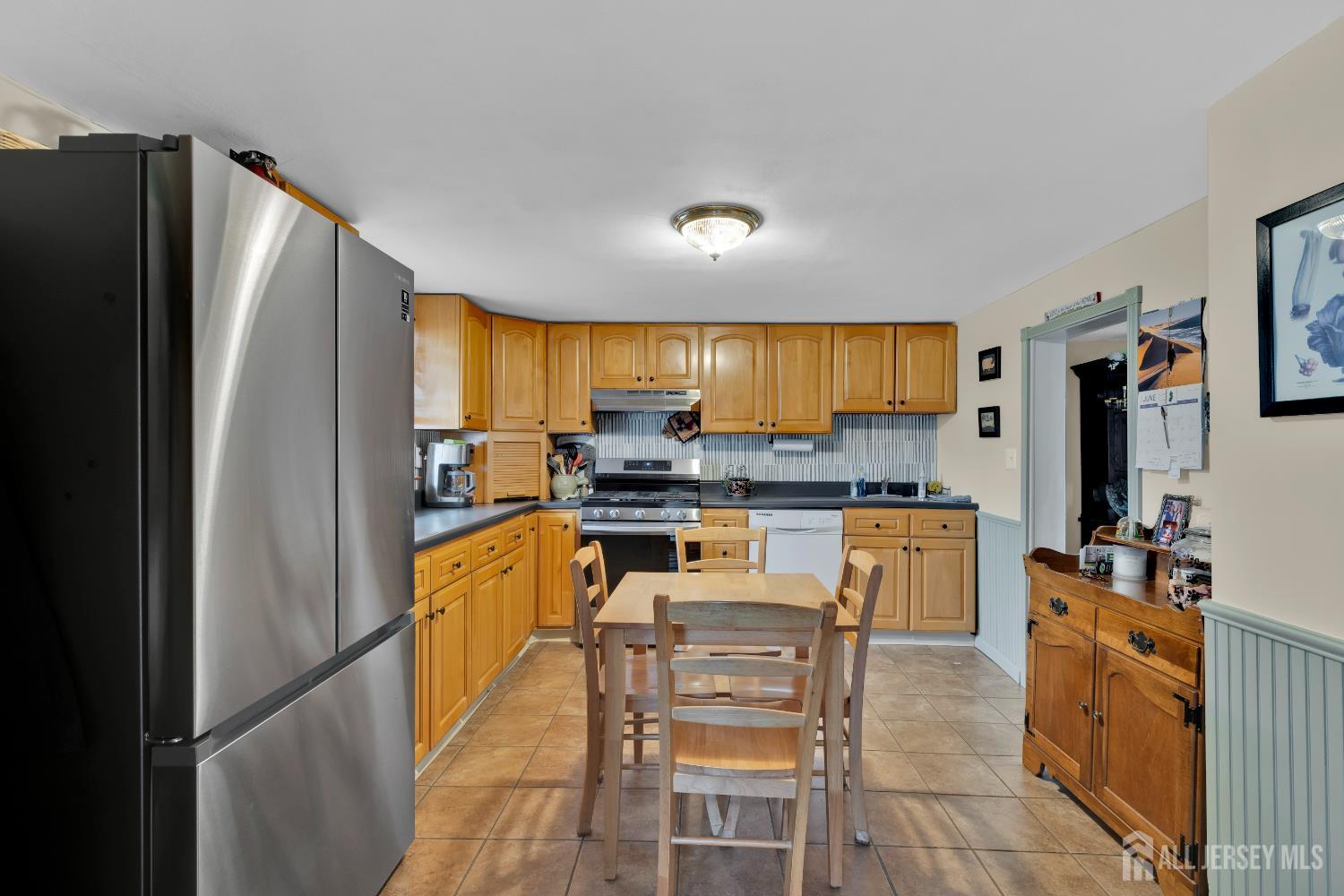 18 Pine Street Keyport, NJ 07735 - Photo 15 of 31 a kitchen with granite countertop stainless steel appliances a refrigerator a stove top oven and a sink