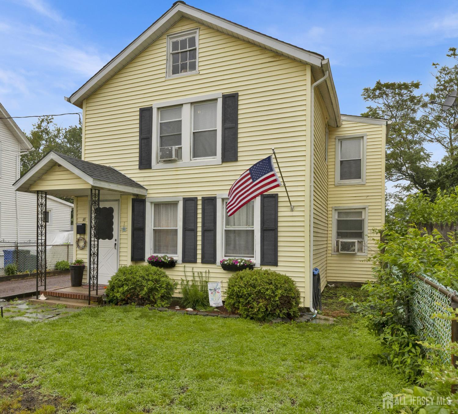 18 Pine Street Keyport, NJ 07735 - Photo 4 of 31 a view of a house with a yard and lawn chairs