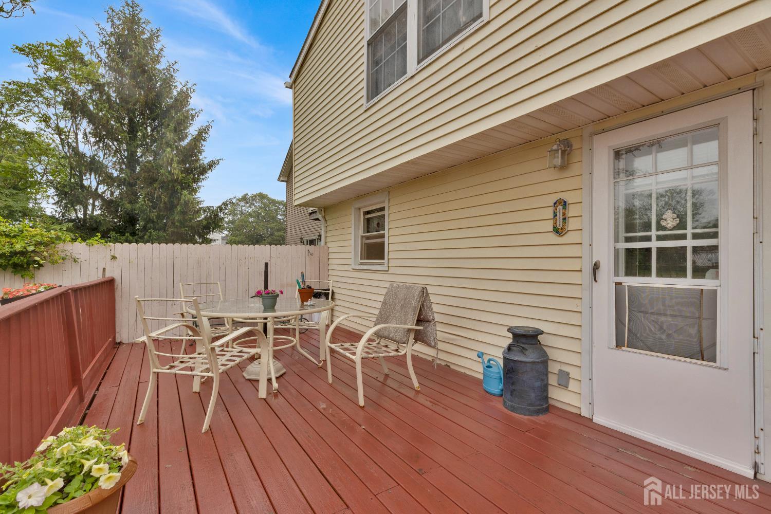 18 Pine Street Keyport, NJ 07735 - Photo 6 of 31 a view of a roof deck with table and chairs floor to ceiling window with wooden floor