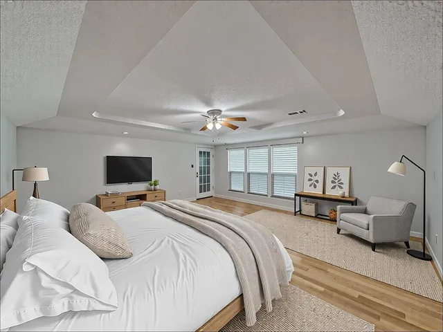 a bedroom with a bed and a flat screen tv