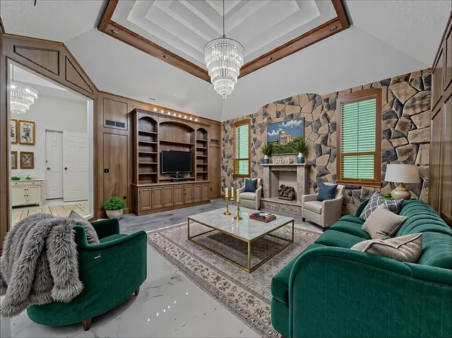 a living room with furniture fireplace and a large window