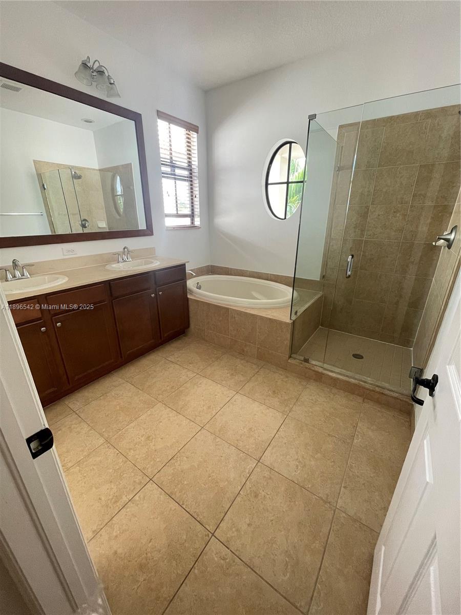 8290 Northwest 39th Court, Unit 8290 Cooper City, FL 33024 - Photo 13 of 19 a spacious bathroom with a granite countertop sink and a mirror