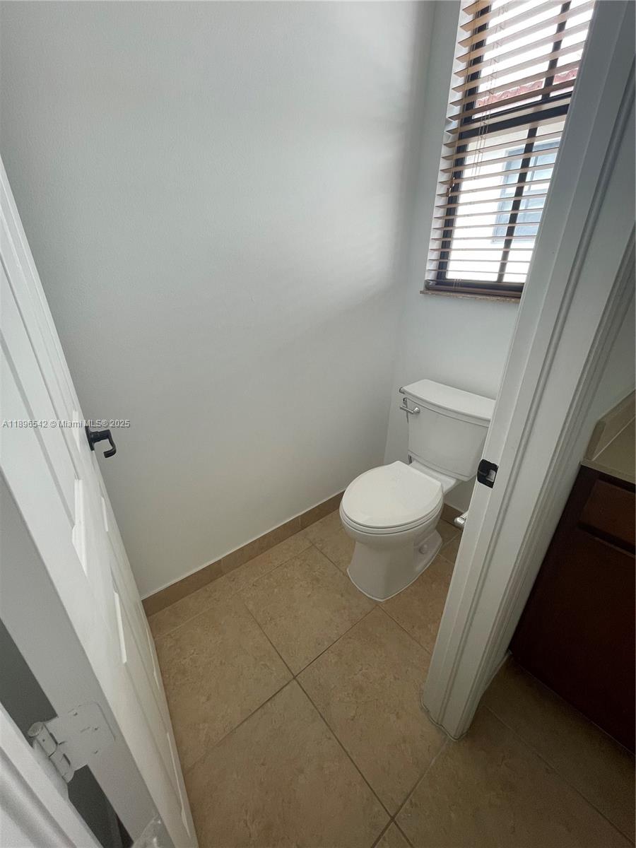 8290 Northwest 39th Court, Unit 8290 Cooper City, FL 33024 - Photo 14 of 19 a bathroom with a toilet and a window