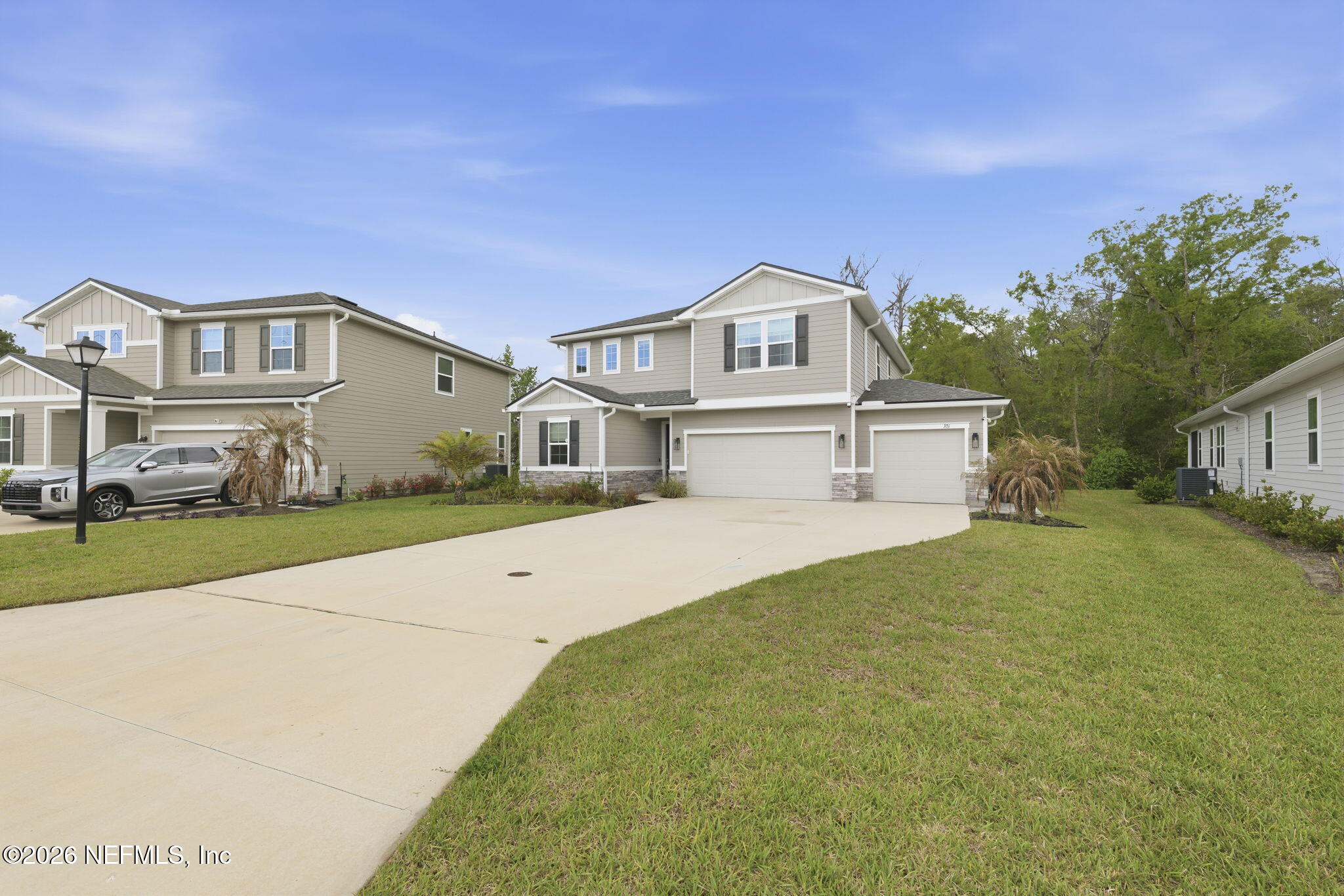301 Field Flower Way St. Augustine, FL 32092 - Photo 2 of 58 a front view of a house with a yard