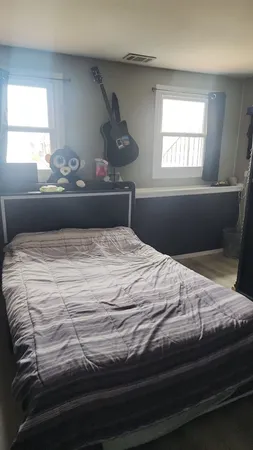 a bedroom with a bed and window