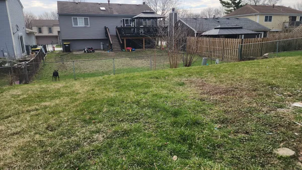 a view of house with a yard