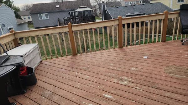a balcony with view of wooden floor