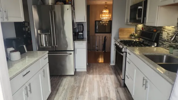 a kitchen with a refrigerator stove and sink