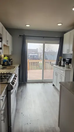 a kitchen with stainless steel appliances granite countertop a stove a sink and a refrigerator