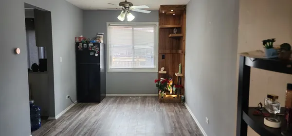a view of a room with wooden floor closet and windows