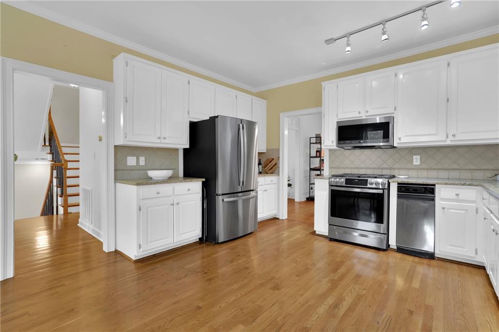 7155 Roswell Road, Unit 14 Atlanta, GA 30328 - Photo 15 of 35 a kitchen with a refrigerator stove and wooden cabinets