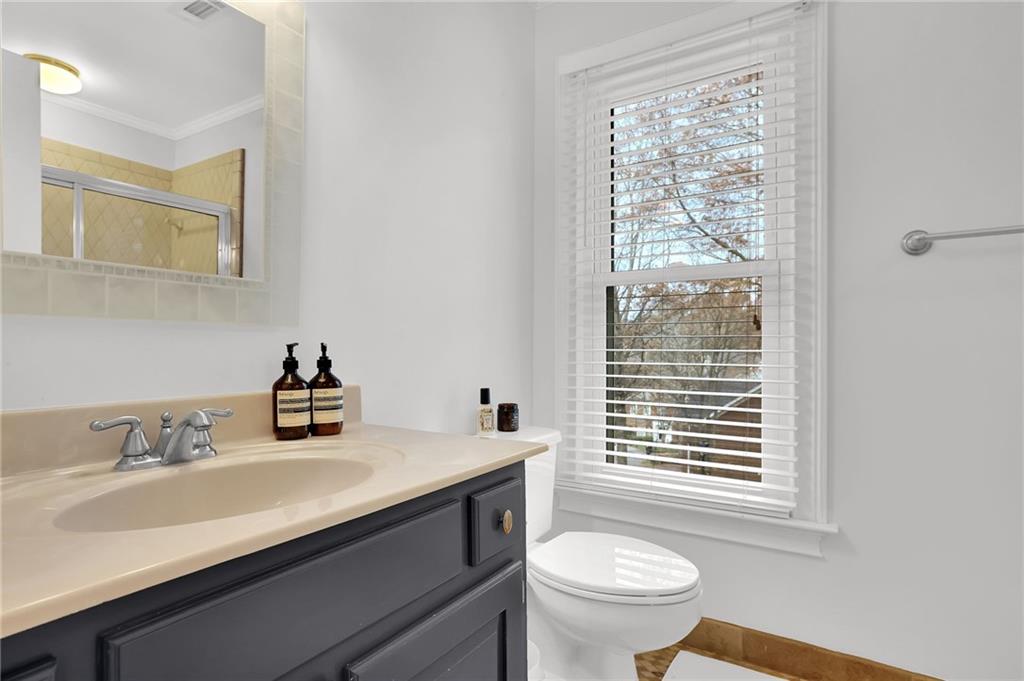 7155 Roswell Road, Unit 14 Atlanta, GA 30328 - Photo 20 of 35 a bathroom with a sink a toilet and a window