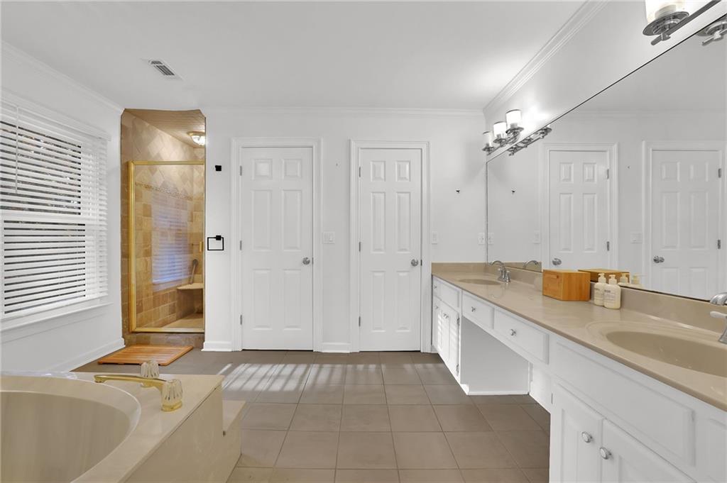 7155 Roswell Road, Unit 14 Atlanta, GA 30328 - Photo 25 of 35 a view of a kitchen with a sink and dishwasher with white cabinets