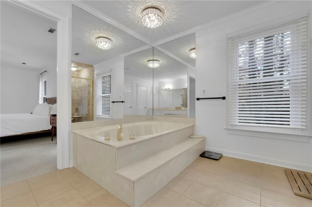 7155 Roswell Road, Unit 14 Atlanta, GA 30328 - Photo 27 of 35 a spacious bathroom with a tub a double vanity sink and a mirror