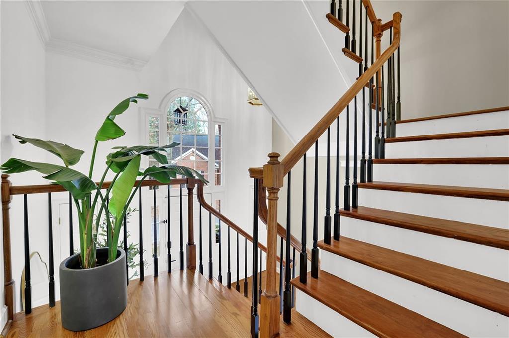 7155 Roswell Road, Unit 14 Atlanta, GA 30328 - Photo 29 of 35 a view of staircase with lots of frames on wall and stairs