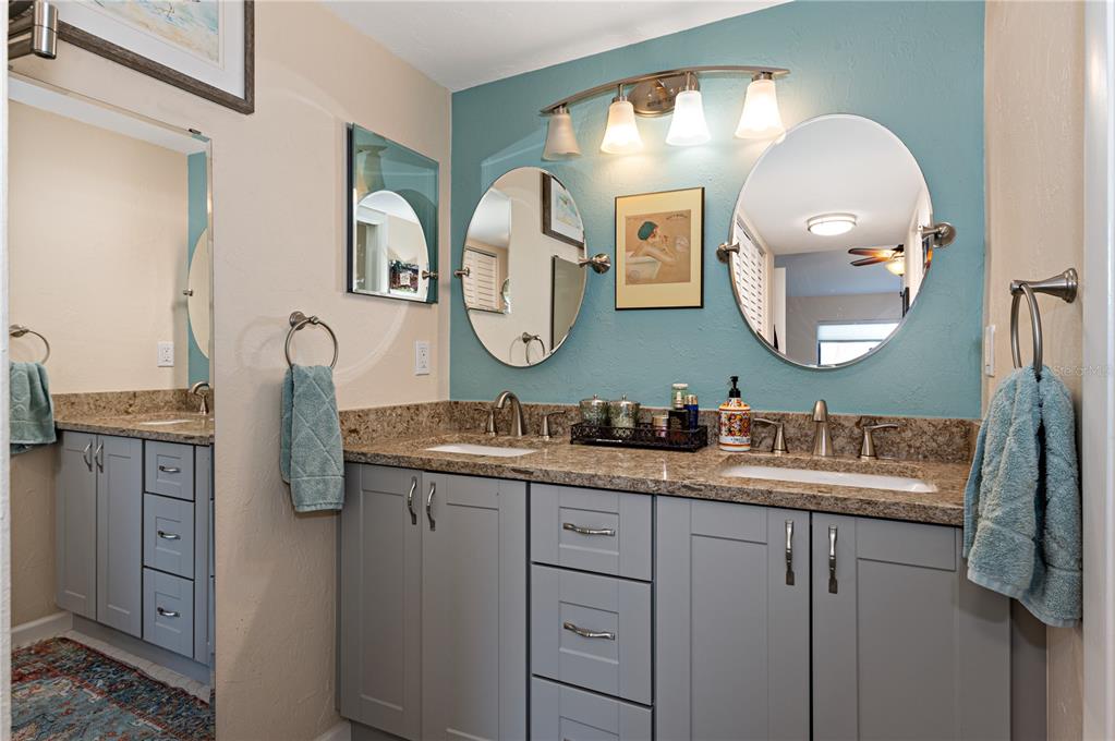 1512 Pelican Cove Road, Unit 239 Sarasota, FL 34231 - Photo 12 of 29 a bathroom with a double vanity sink and a mirror