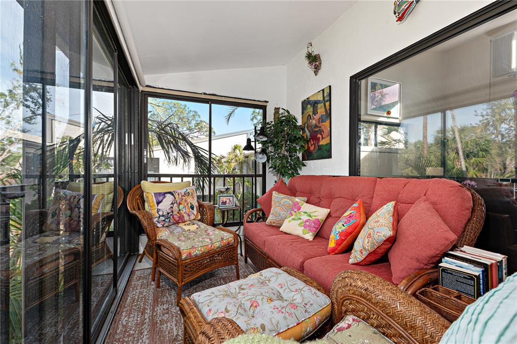 1512 Pelican Cove Road, Unit 239 Sarasota, FL 34231 - Photo 13 of 29 a bedroom with furniture and a large window