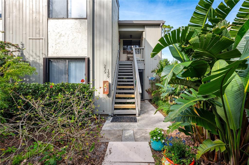 1512 Pelican Cove Road, Unit 239 Sarasota, FL 34231 - Photo 2 of 29 a view of a potted plants in front of a building