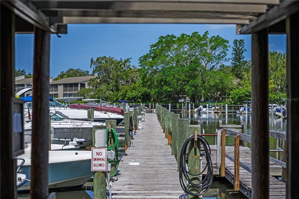 1512 Pelican Cove Road, Unit 239 Sarasota, FL 34231 - Photo 21 of 29 a view of a balcony with chairs and wooden floor