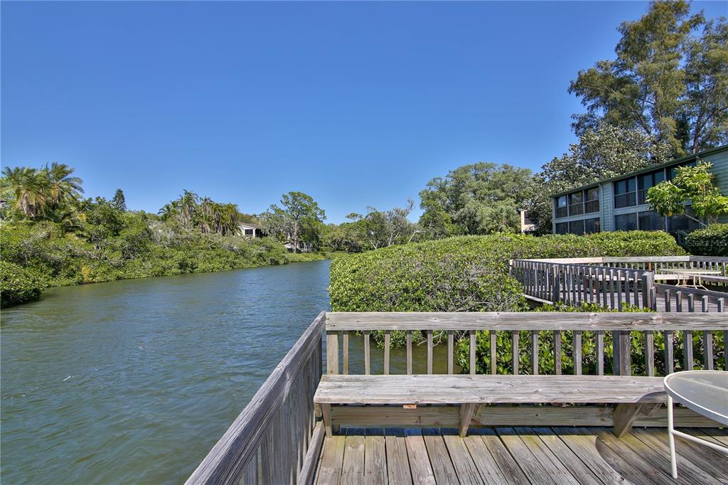 1512 Pelican Cove Road, Unit 239 Sarasota, FL 34231 - Photo 28 of 29 a view of a roof deck with wooden floor and fence