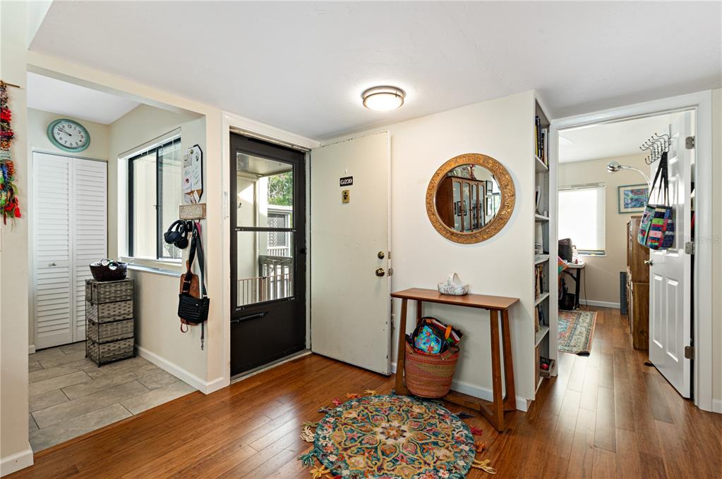 1512 Pelican Cove Road, Unit 239 Sarasota, FL 34231 - Photo 4 of 29 a view of a hallway with entryway wooden floor and front door