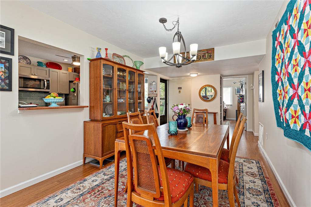 1512 Pelican Cove Road, Unit 239 Sarasota, FL 34231 - Photo 6 of 29 a view of a dining room with furniture and chandelier
