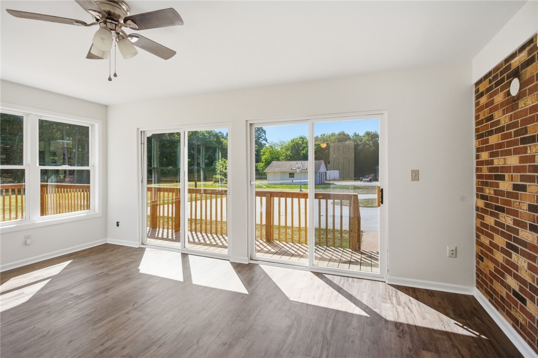 207 Greenmeadow Circle Anderson, SC 29626 - Photo 14 of 38 This bright space features sleek flooring, a classic brick accent wall, and a deck for seamless indoor-outdoor living.