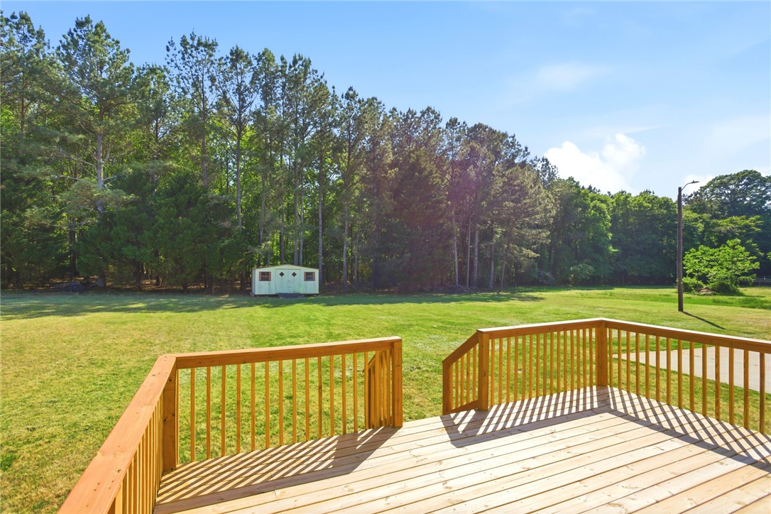 207 Greenmeadow Circle Anderson, SC 29626 - Photo 32 of 38 Enjoy outdoor living on this expansive wooden deck, overlooking a verdant lawn and mature trees.