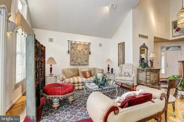 a living room with furniture fireplace and a large window