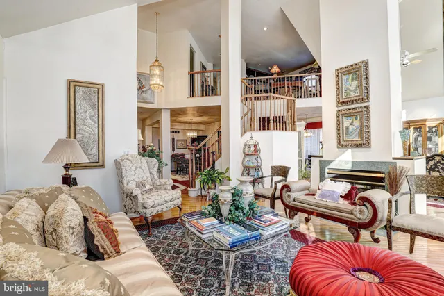 a living room with furniture fireplace and a large window