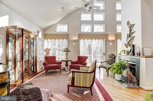 a living room with furniture a rug and a large window