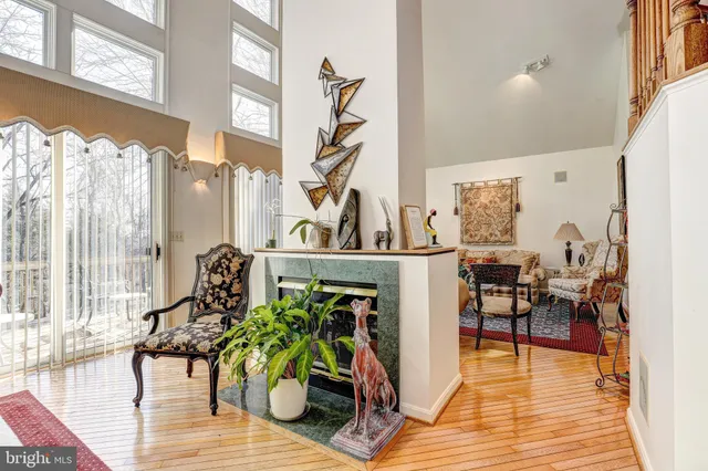 a kitchen with stainless steel appliances granite countertop a stove top oven a refrigerator a sink and chairs