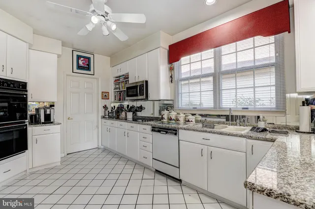 a view of a dining room with furniture a chandelier and wooden floor