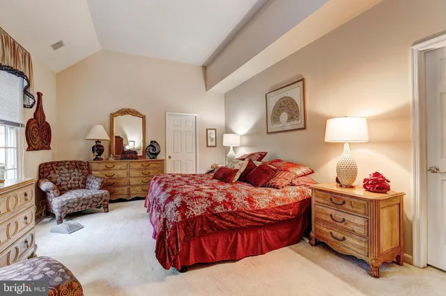 a living room with furniture a rug and a book shelf