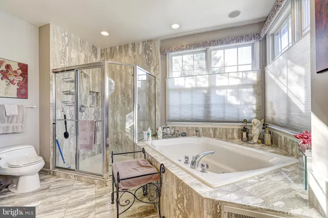 a bedroom with a bed window and couch