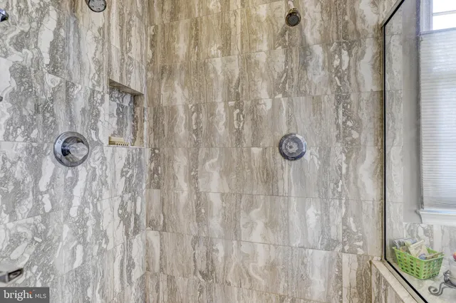 a spacious bedroom with a bed and window