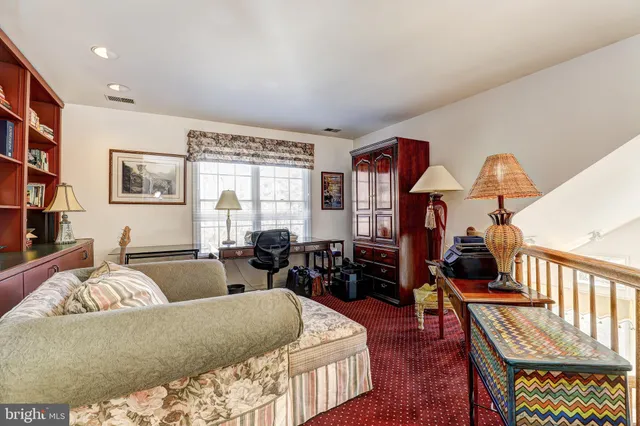 a living room with furniture a piano and a fireplace