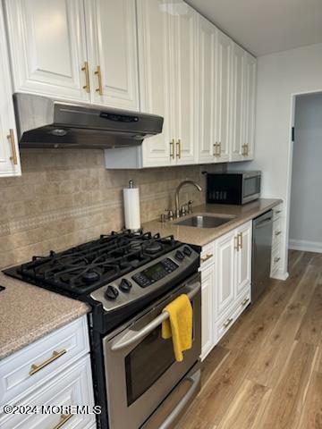675 Ocean Avenue, Unit 3I Long Branch, NJ 07740 - Photo 14 of 35 a kitchen with granite countertop a stove and a microwave