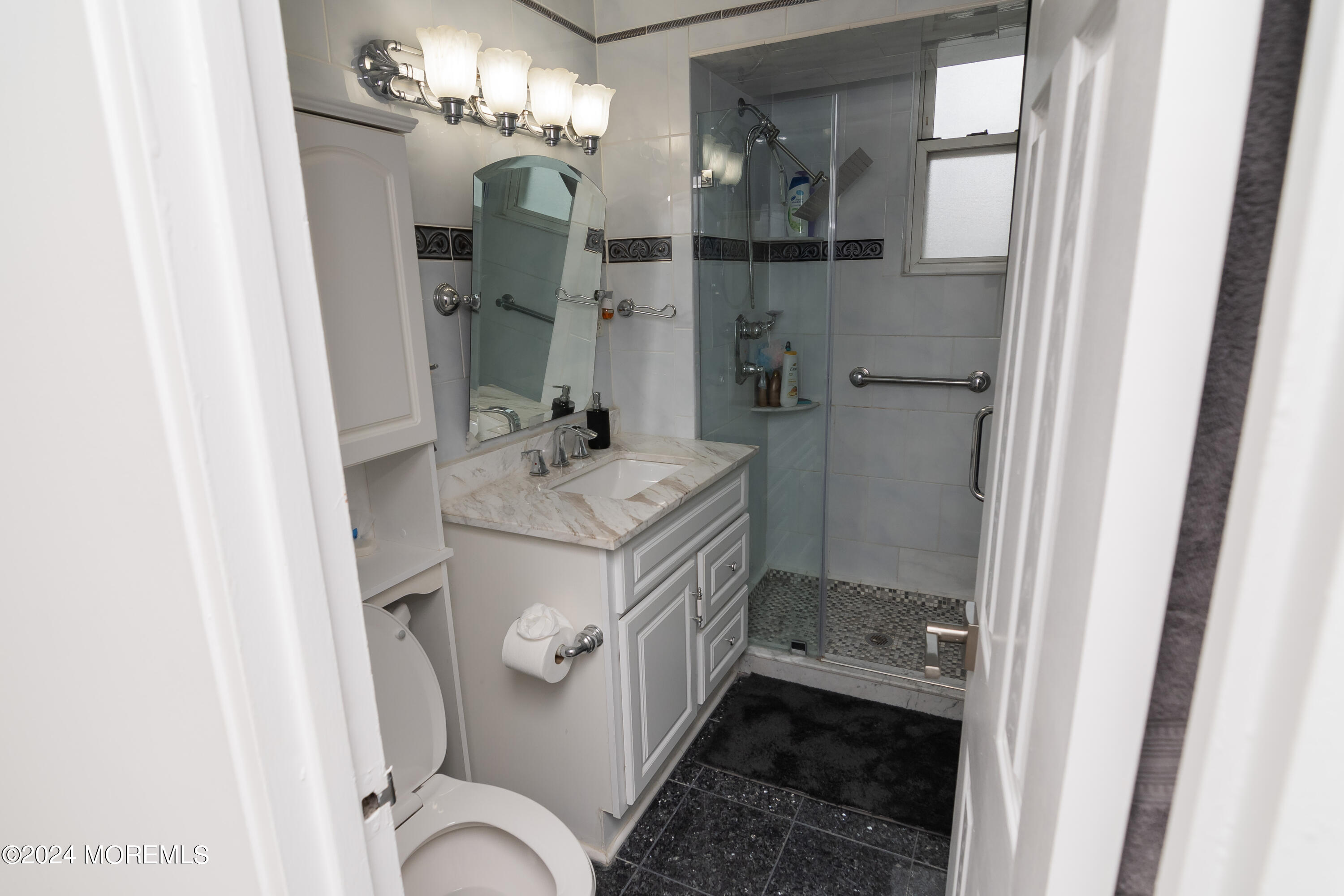 675 Ocean Avenue, Unit 3I Long Branch, NJ 07740 - Photo 17 of 35 a bathroom with a sink a toilet and shower