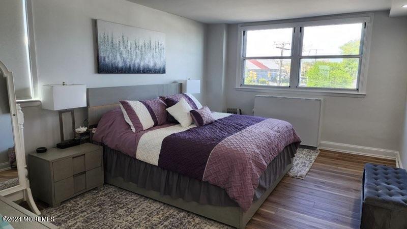 675 Ocean Avenue, Unit 3I Long Branch, NJ 07740 - Photo 19 of 35 a bedroom with a bed and wooden floor