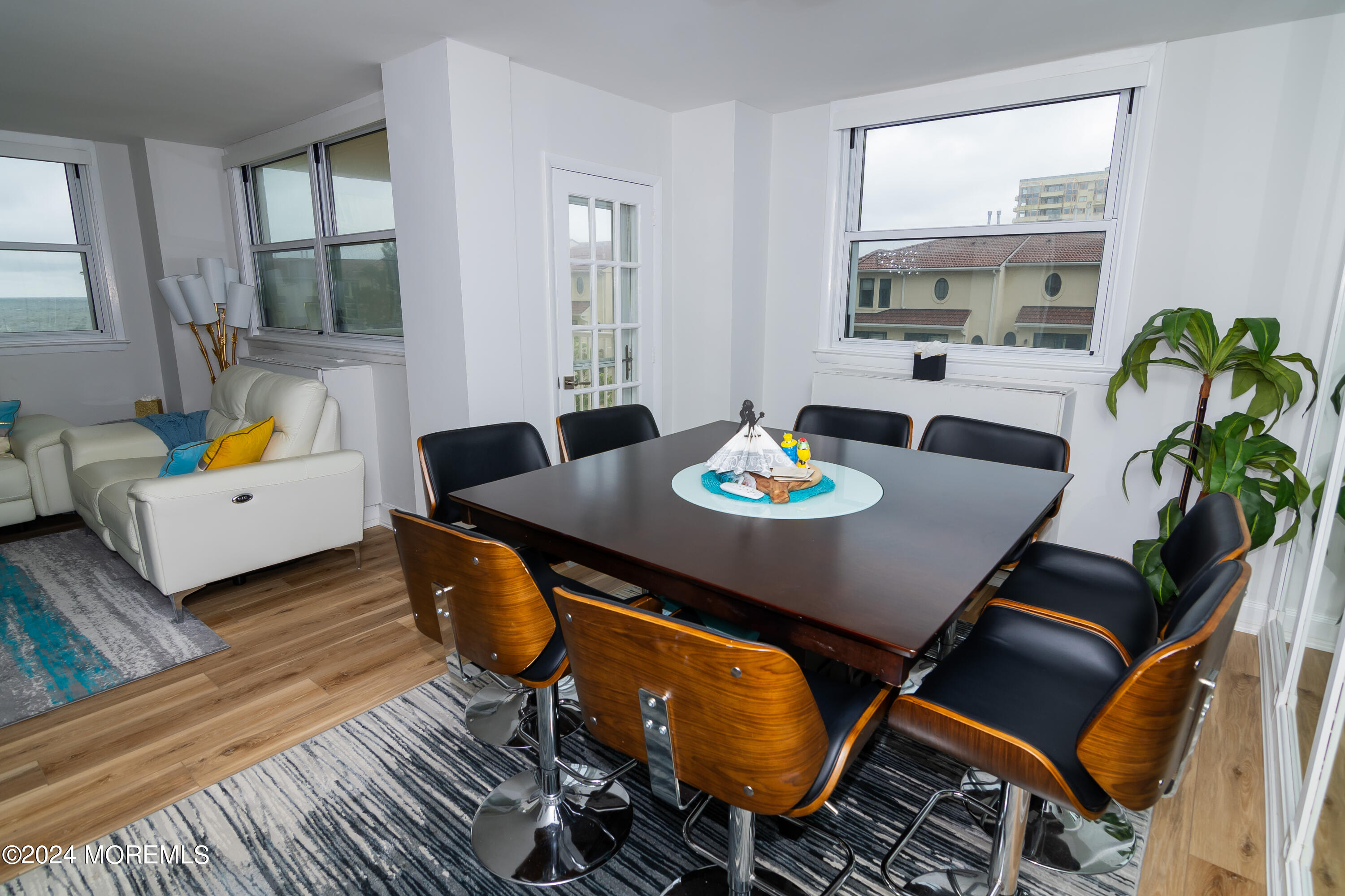 675 Ocean Avenue, Unit 3I Long Branch, NJ 07740 - Photo 10 of 35 a view of a dining room with furniture a potted plant and wooden floor