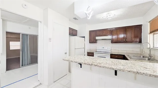 a kitchen with stainless steel appliances granite countertop a sink stove and cabinets