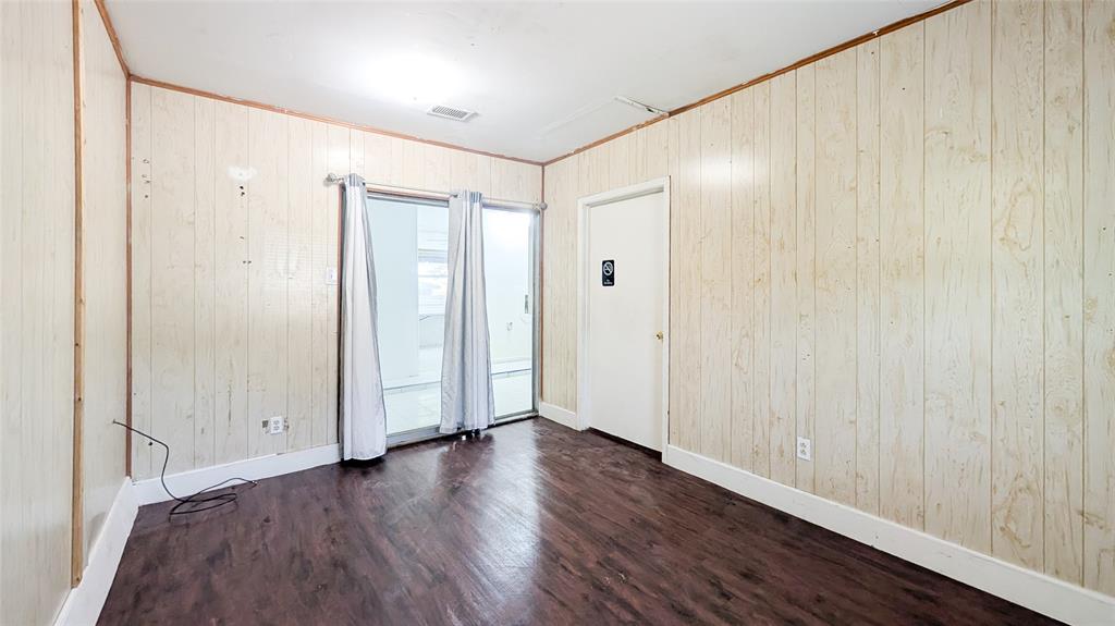 1107 Waverly Drive Arlington, TX 76015 - Photo 17 of 20 a view of an empty room with wooden floor