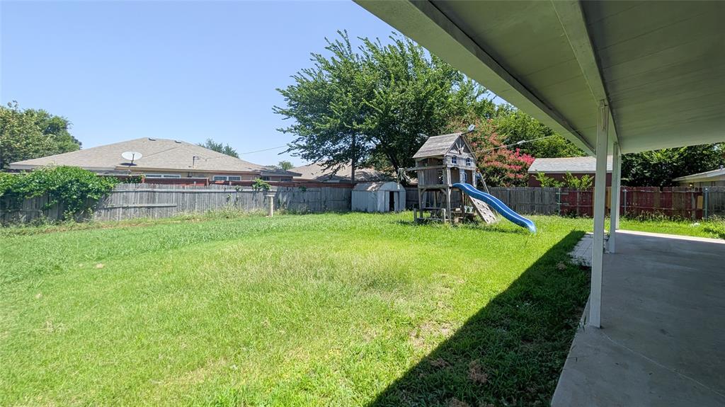 1107 Waverly Drive Arlington, TX 76015 - Photo 19 of 20 a view of a house with a yard and a palm tree